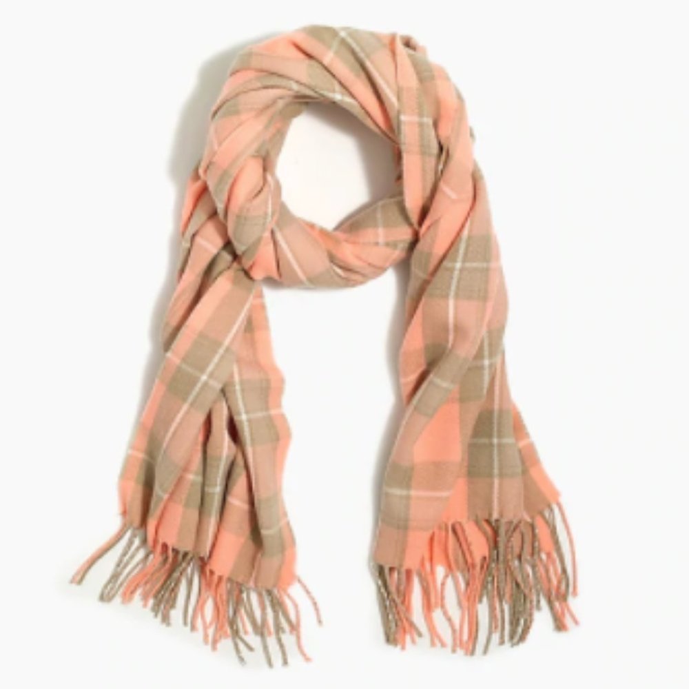 This J.Crew classic plaid scarf in pink and camel features a soft, fringed tasse